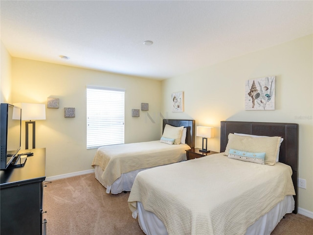 bedroom featuring light colored carpet