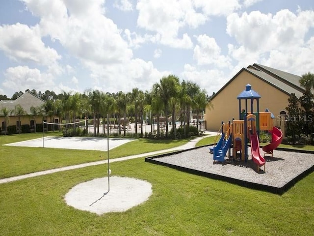 view of play area with a lawn and volleyball court