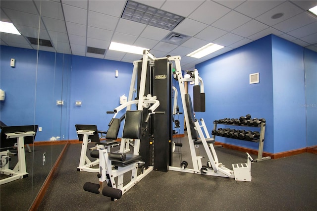 workout area with a paneled ceiling