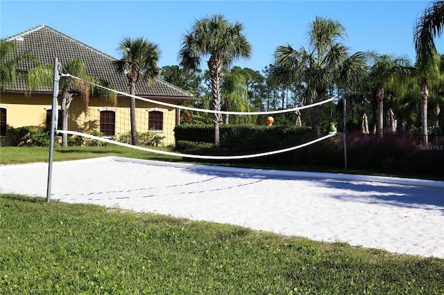 view of property's community with volleyball court and a yard