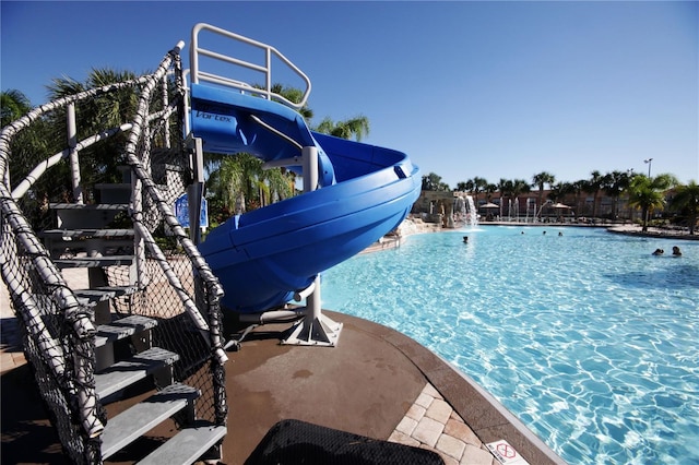 view of swimming pool featuring pool water feature and a water slide