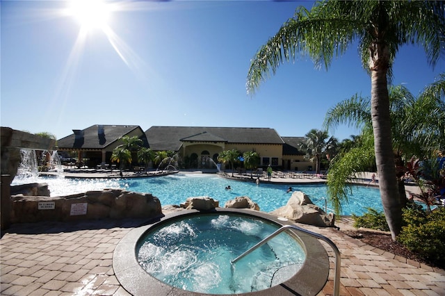 view of pool with a community hot tub and pool water feature