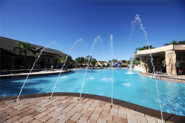 view of swimming pool with pool water feature