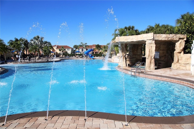 view of swimming pool with a water slide