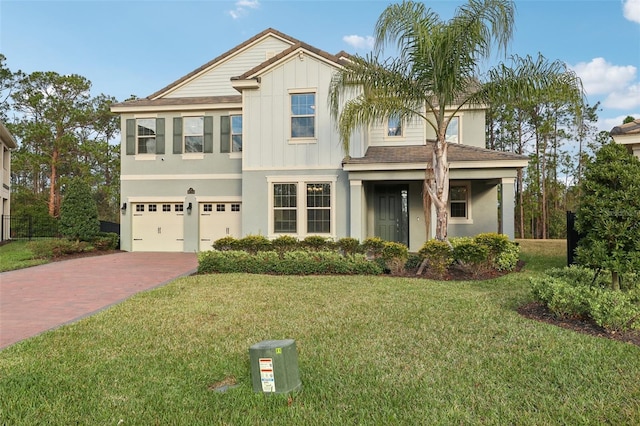 view of front of home with a front lawn and a garage