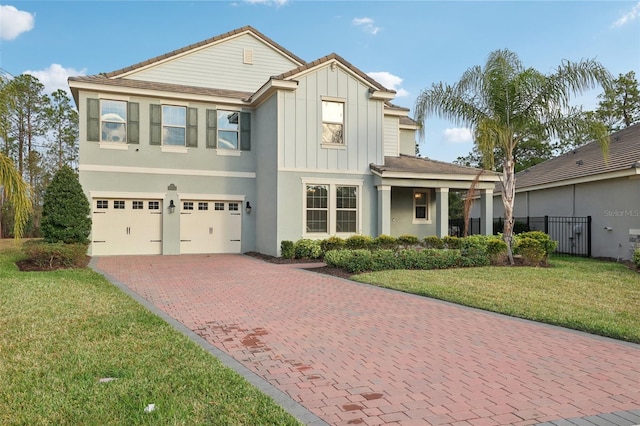 view of front facade with a garage and a front lawn