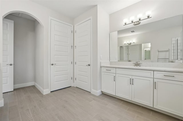 bathroom with hardwood / wood-style floors and vanity