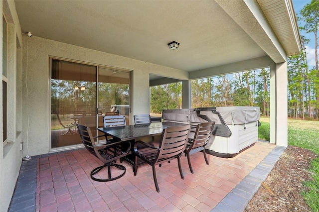 view of patio / terrace with area for grilling and a hot tub