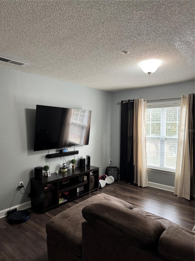 living room with a textured ceiling and hardwood / wood-style flooring