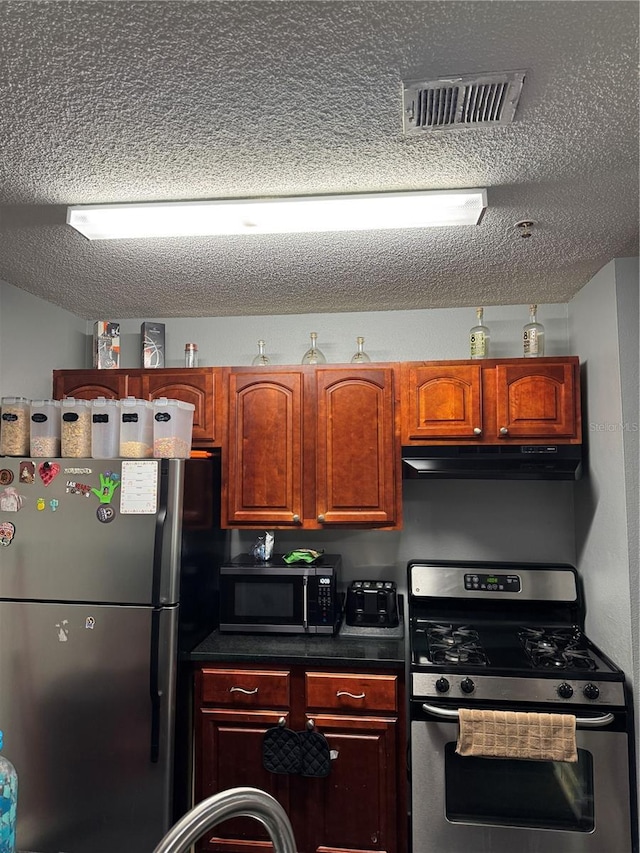 kitchen featuring stainless steel appliances and a textured ceiling