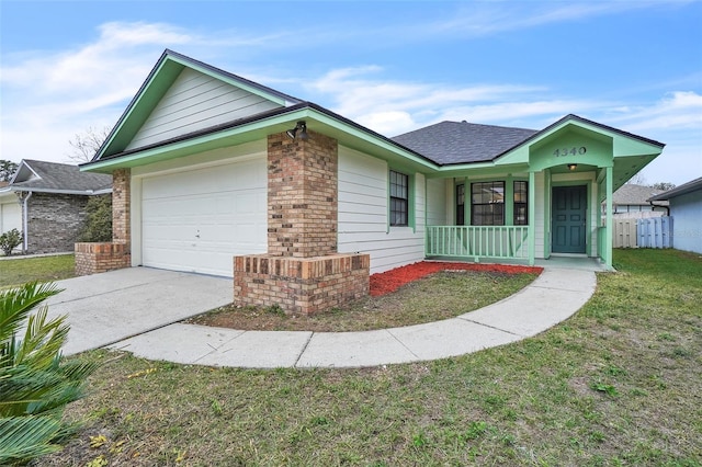 ranch-style house with a garage, a front yard, and covered porch