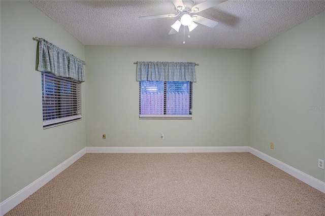 carpeted empty room featuring a textured ceiling and ceiling fan