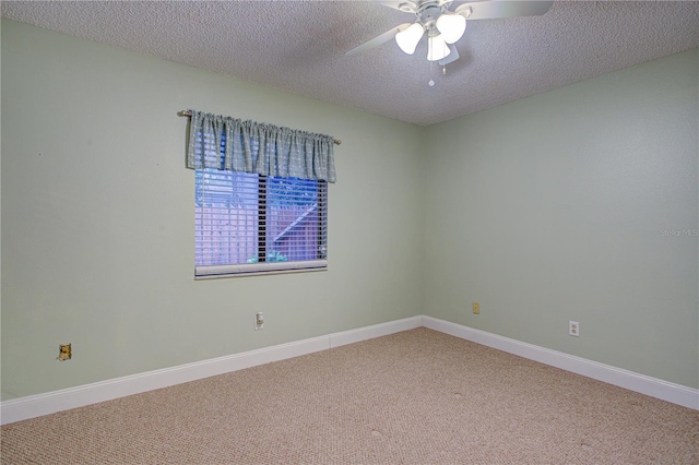 empty room with ceiling fan, a textured ceiling, and carpet flooring