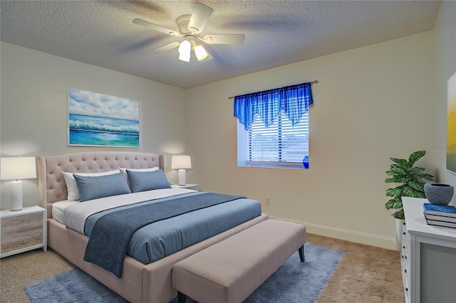 carpeted bedroom featuring ceiling fan and a textured ceiling