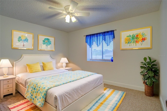 carpeted bedroom with ceiling fan and a textured ceiling