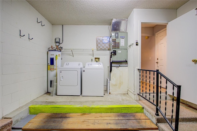 laundry area featuring washer and dryer, a textured ceiling, electric water heater, and heating unit