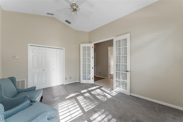 sitting room with french doors, ceiling fan, vaulted ceiling, and light colored carpet