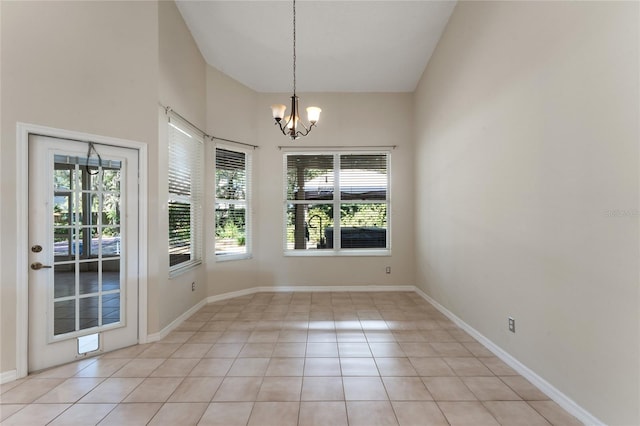 unfurnished dining area featuring an inviting chandelier, plenty of natural light, and light tile patterned floors