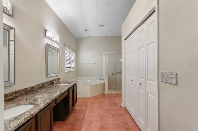 bathroom with lofted ceiling, vanity, tile patterned floors, and independent shower and bath