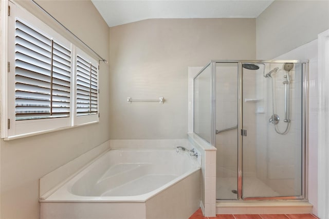 bathroom featuring vaulted ceiling and separate shower and tub