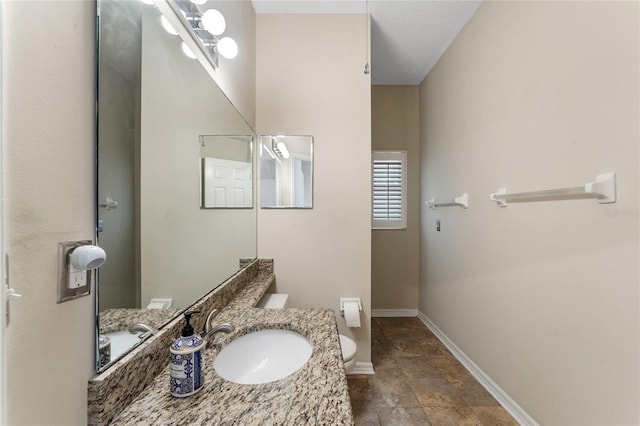 bathroom featuring toilet and vanity