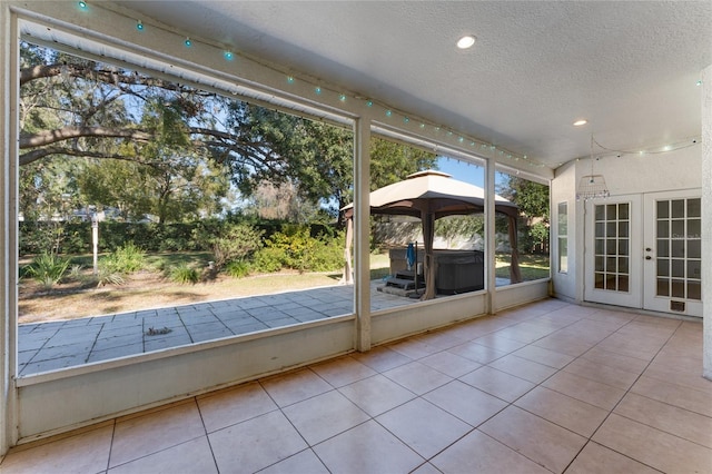 unfurnished sunroom featuring french doors