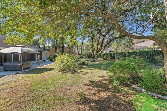 view of yard featuring a hot tub and a gazebo