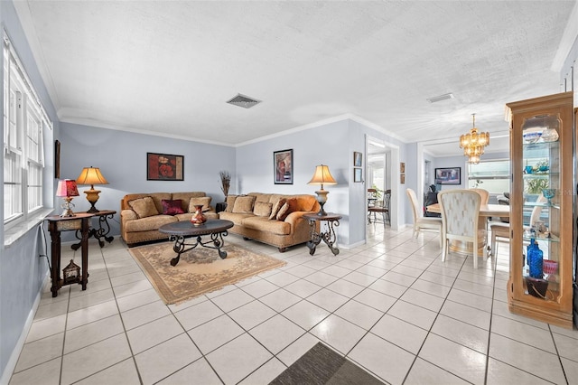 living room with ornamental molding, a notable chandelier, light tile patterned flooring, and a textured ceiling