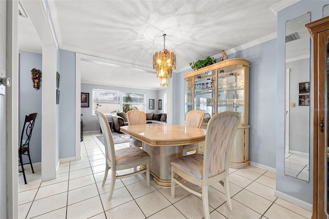 tiled dining space featuring a notable chandelier and ornamental molding