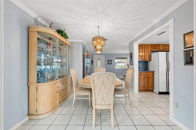 tiled dining area with ornamental molding and a notable chandelier