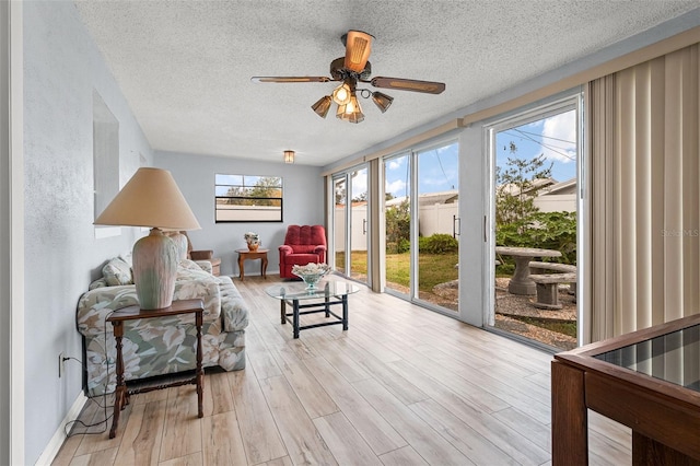 sunroom / solarium with ceiling fan