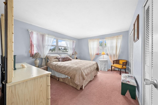 carpeted bedroom featuring multiple windows