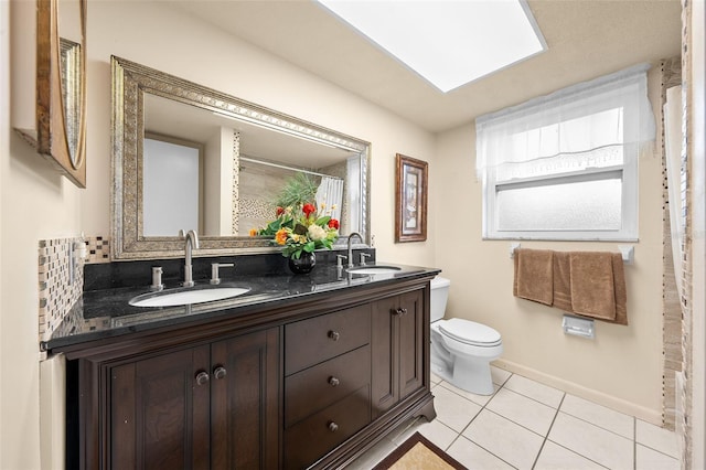 bathroom with vanity, tile patterned floors, decorative backsplash, and toilet