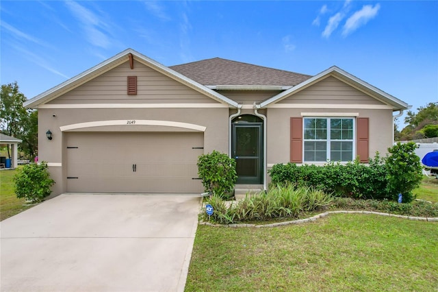 view of front facade with a front lawn and a garage