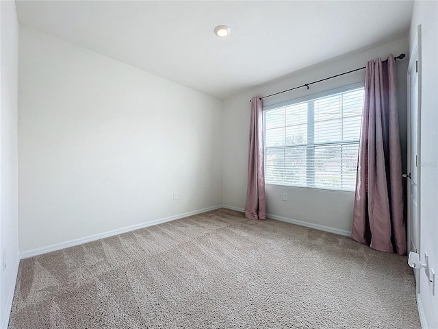 spare room with light carpet