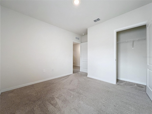 unfurnished bedroom featuring a closet and carpet