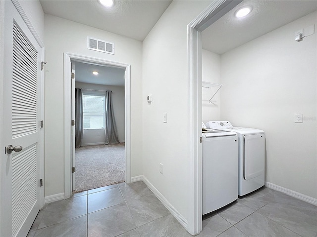 washroom with light tile patterned flooring and independent washer and dryer