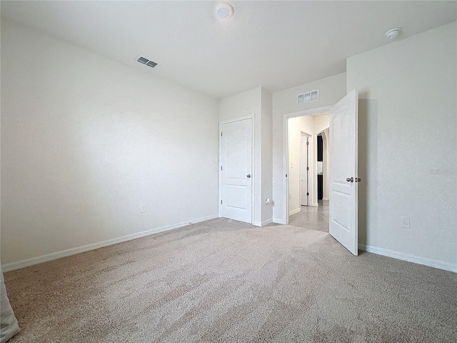 unfurnished bedroom featuring light colored carpet