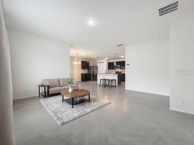 living room featuring a notable chandelier and sink