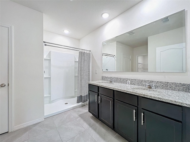 bathroom featuring tile patterned floors, vanity, and a shower with curtain