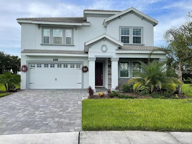 view of front of property featuring a front yard and a garage