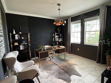 office with a textured ceiling and crown molding