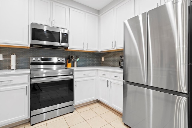 kitchen featuring white cabinets, light tile patterned floors, tasteful backsplash, and stainless steel appliances