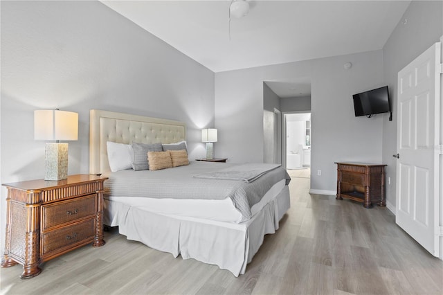 bedroom with light hardwood / wood-style flooring and ensuite bath