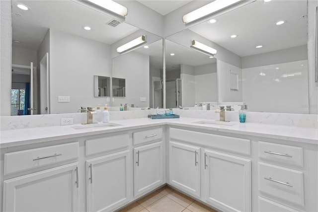 bathroom with tile patterned floors, walk in shower, and vanity