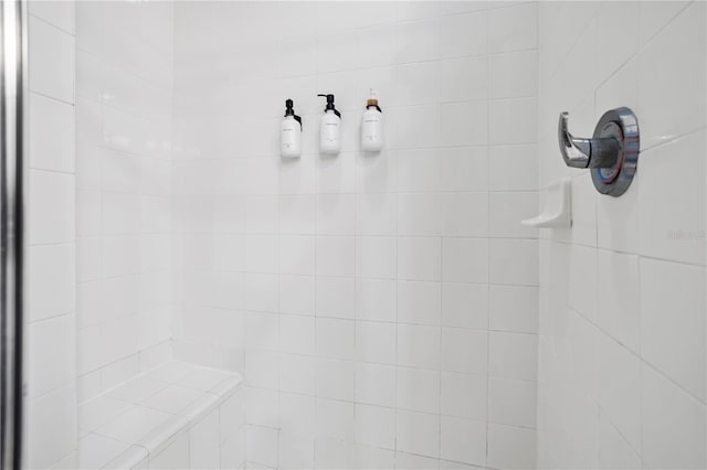 interior details featuring tiled shower