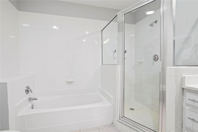 bathroom featuring vanity, independent shower and bath, and tile patterned flooring