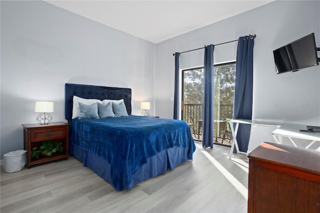 bedroom featuring light hardwood / wood-style floors and access to outside