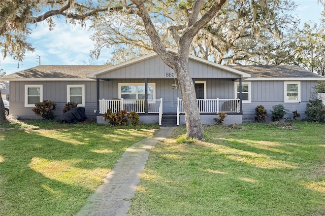 ranch-style house featuring a porch and a front lawn