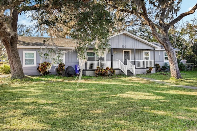 ranch-style house with a porch and a front lawn